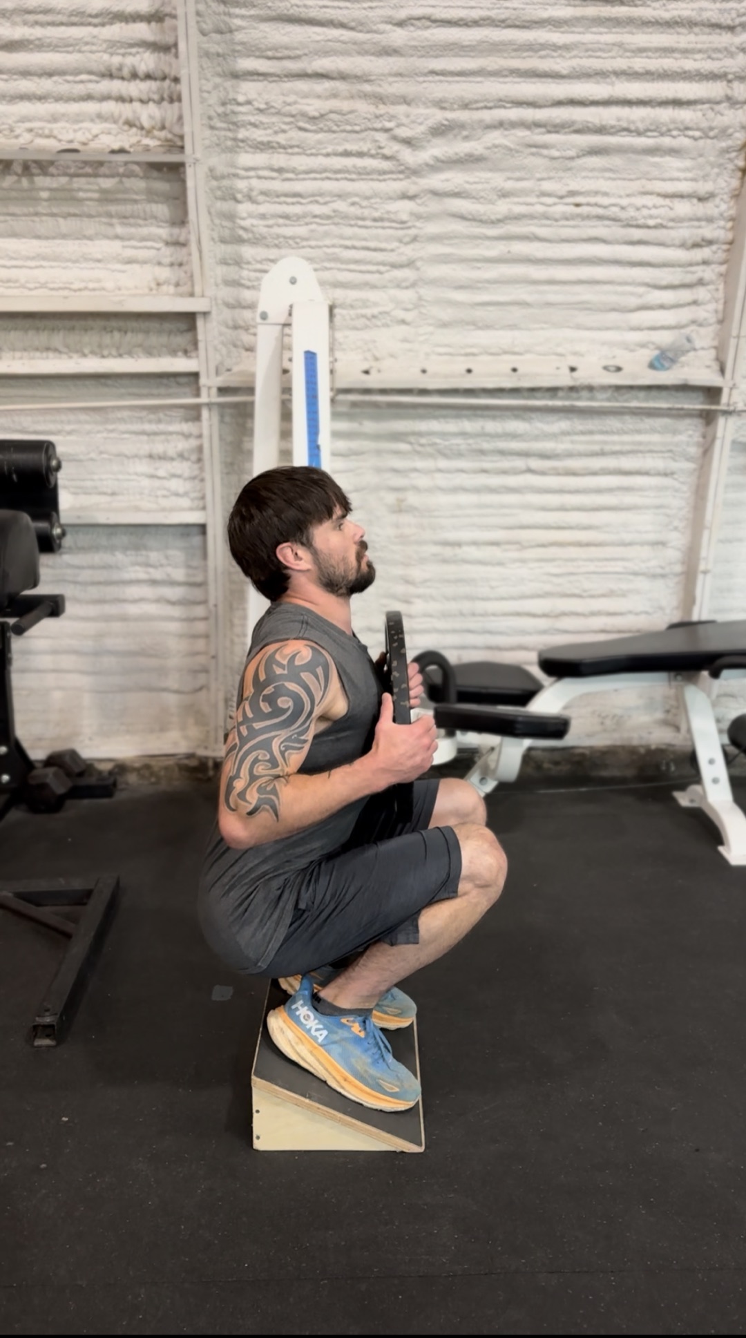 Client performing a VMO-focused squat variation
