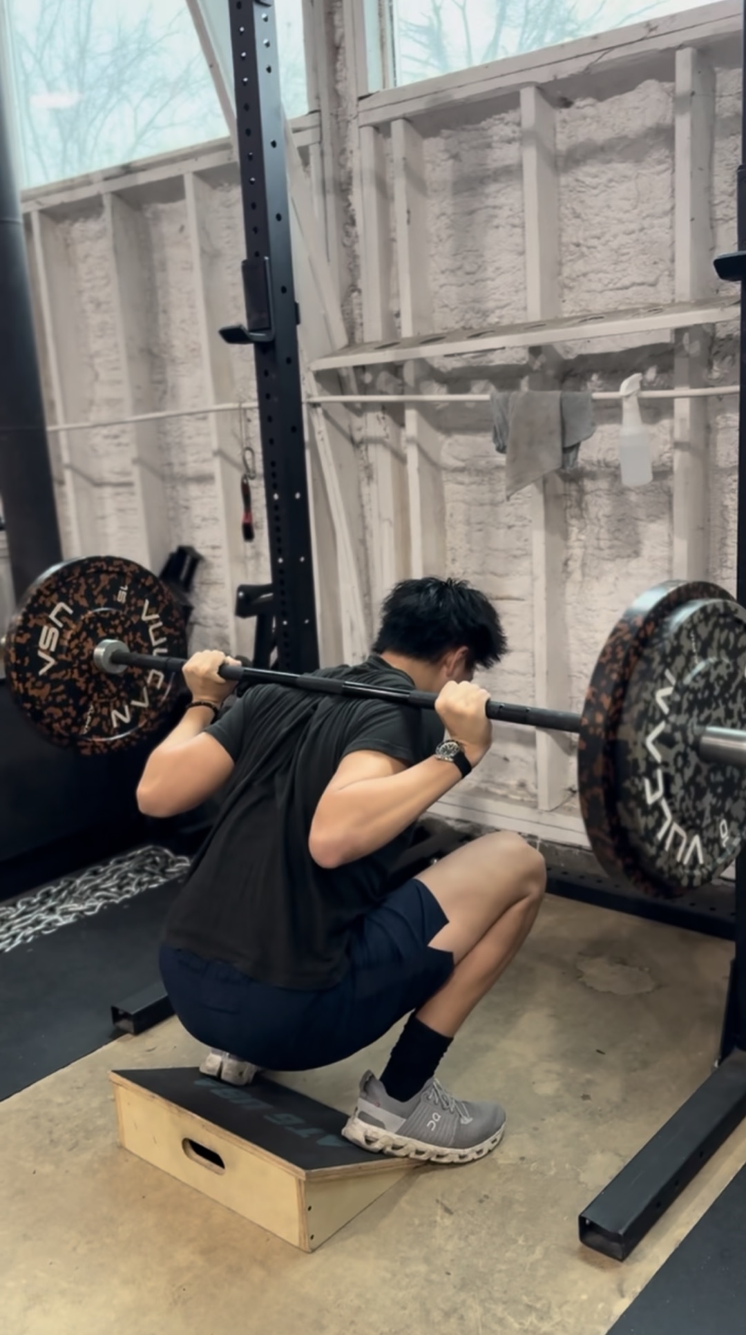 Client performing a barbell back squat